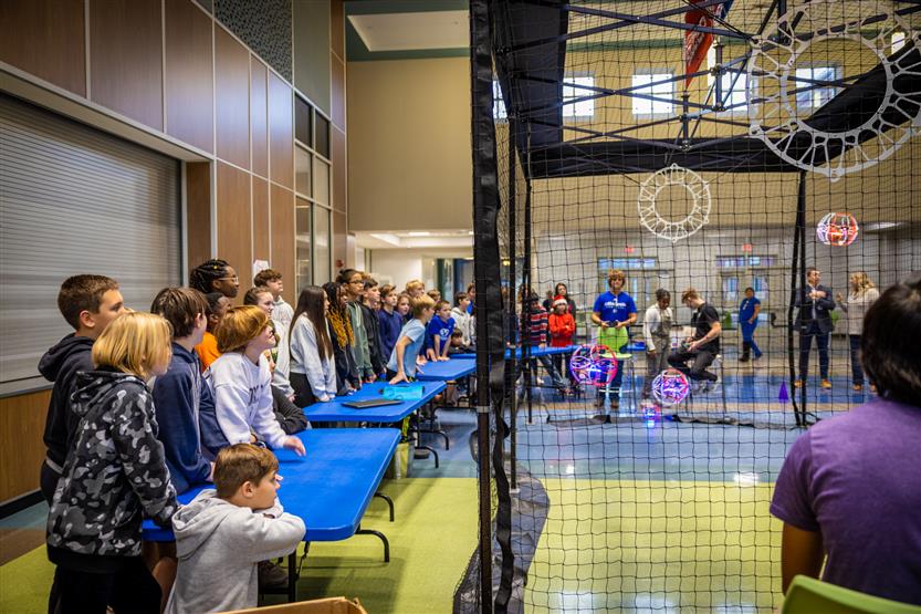 Middle and high school students learning about drone soccer